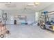 Two car garage with storage cabinets, golf cart, and interior access to the home via stairs at 2327 Morning Glory Trl, Spring Hill, FL 34606