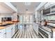 Open kitchen with stainless appliances, butcher block counters, and breakfast nook by a sunlit bay window at 2327 Morning Glory Trl, Spring Hill, FL 34606