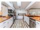 Modern kitchen features stainless steel appliances, wood countertops, and stylish tiled backsplash at 2327 Morning Glory Trl, Spring Hill, FL 34606