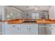 Updated kitchen with butcher block countertops, stainless steel dishwasher, and open design overlooking living area at 2327 Morning Glory Trl, Spring Hill, FL 34606