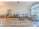 Cozy living room featuring modern furniture, wood flooring, and natural light from a large window at 2327 Morning Glory Trl, Spring Hill, FL 34606