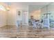 Open-concept living area with wood flooring and mirrored wall, creating an airy atmosphere at 2327 Morning Glory Trl, Spring Hill, FL 34606