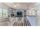 Open concept living space with hardwood floors, fireplace, and plenty of natural light that create a peaceful living area at 2327 Morning Glory Trl, Spring Hill, FL 34606