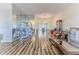 Bright living room featuring wood floors, and a large mirror accent wall that makes the space feel even bigger at 2327 Morning Glory Trl, Spring Hill, FL 34606