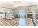Cozy living room with a fireplace, neutral decor, and hardwood floors creating a warm and inviting atmosphere at 2327 Morning Glory Trl, Spring Hill, FL 34606