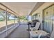 Screened patio with tables, seating, and views of the backyard at 2327 Morning Glory Trl, Spring Hill, FL 34606