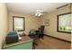 A bright office space with two desks, carpet, and natural light from two windows at 23409 Dogwood Estates Dr, Brooksville, FL 34601