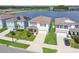 Aerial view of neighborhood homes with manicured lawns and serene lake views, showcasing community living at 3208 Living Coral Dr, Odessa, FL 33556