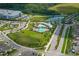 Overhead view showcasing community amenities including pools, playground, and green spaces at 3208 Living Coral Dr, Odessa, FL 33556