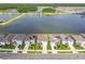 Neighborhood homes with manicured lawns around a lake, illustrating a picturesque community setting at 3208 Living Coral Dr, Odessa, FL 33556