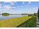 Enjoy serene lake views from this spacious backyard with well-maintained lawn and black aluminum fence at 3208 Living Coral Dr, Odessa, FL 33556