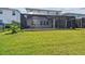 Expansive backyard featuring a screened-in patio perfect for outdoor entertaining and relaxation at 3208 Living Coral Dr, Odessa, FL 33556
