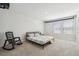 Bright, minimalist bedroom featuring a comfortable bed, complemented by natural light streaming through the windows at 3208 Living Coral Dr, Odessa, FL 33556