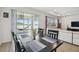 Dining area with a view of the lake, featuring a table with seating and access to an outdoor patio at 3208 Living Coral Dr, Odessa, FL 33556