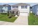 Well-maintained two-story home with blue shutters, stone accents, manicured lawn, and a two-car garage at 3208 Living Coral Dr, Odessa, FL 33556