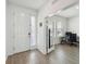 Bright foyer with wood-look floors and an open view to a home office space at 3208 Living Coral Dr, Odessa, FL 33556
