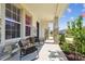 Inviting front porch with chairs and plants, offering a relaxing outdoor space at 3208 Living Coral Dr, Odessa, FL 33556