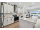 Bright kitchen with white cabinets, stainless steel appliances, and a view of the lake at 3208 Living Coral Dr, Odessa, FL 33556