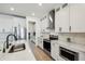 Beautiful kitchen with stainless steel appliances, white cabinets, and a stylish range hood at 3208 Living Coral Dr, Odessa, FL 33556