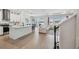 Open floor plan showcasing a modern kitchen and living area with bright, natural light at 3208 Living Coral Dr, Odessa, FL 33556