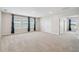 Large upstairs loft with multiple windows, carpet, and white walls and trim at 3208 Living Coral Dr, Odessa, FL 33556
