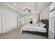 Main bedroom with a tray ceiling, ceiling fan, and attached bath at 3208 Living Coral Dr, Odessa, FL 33556