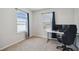 Home office with a large window overlooking a lake and equipped with a modern desk and office chair at 3208 Living Coral Dr, Odessa, FL 33556