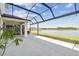 Enclosed patio featuring a clear view of the lake and green landscaping, ideal for relaxation and outdoor enjoyment at 3208 Living Coral Dr, Odessa, FL 33556