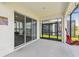 Enclosed patio with comfortable seating and a picturesque lake view, perfect for relaxing and outdoor enjoyment at 3208 Living Coral Dr, Odessa, FL 33556