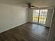 Room featuring laminate flooring, ceiling fan, natural light from a large window, and closet at 3617 Rockaway Dr, Holiday, FL 34691