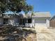 Charming single-story home featuring an attached garage, a brick walkway, and mature landscaping at 3617 Rockaway Dr, Holiday, FL 34691