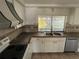Functional kitchen features stainless steel appliances, a double sink, and ample cabinet space at 3617 Rockaway Dr, Holiday, FL 34691