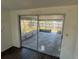 Bright room with laminate flooring and sliding glass door leading to an enclosed patio at 3617 Rockaway Dr, Holiday, FL 34691