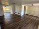 Open-concept living room boasting wood-look flooring, multiple windows, and a neutral color palette at 3617 Rockaway Dr, Holiday, FL 34691