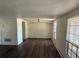 Spacious living room featuring laminate flooring and abundant natural light from multiple windows at 3617 Rockaway Dr, Holiday, FL 34691