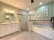 Beautiful bathroom featuring a bathtub, tiled shower, and double vanity at 3655 Square West Ln # 9, Sarasota, FL 34238