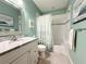 Charming bathroom with grey marble countertops, soft blue walls, tub and shower combination, and marine decor at 3655 Square West Ln # 9, Sarasota, FL 34238