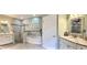 Well-lit bathroom with a separate tub, a walk-in shower, and a double vanity with granite countertops at 3655 Square West Ln # 9, Sarasota, FL 34238