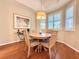 Cozy dining area with natural light and hardwood floors with shuttered windows at 3655 Square West Ln # 9, Sarasota, FL 34238