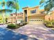 Charming townhouse featuring a tile roof, two-car garage, and lush landscaping at 3655 Square West Ln # 9, Sarasota, FL 34238