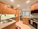 Bright kitchen featuring stainless steel appliances, granite countertops and light wood cabinetry at 3655 Square West Ln # 9, Sarasota, FL 34238