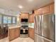 Bright kitchen featuring stainless steel appliances, granite countertops and light wood cabinetry at 3655 Square West Ln # 9, Sarasota, FL 34238