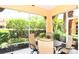 Screened-in lanai with a dining table and seating area, perfect for enjoying the serene outdoor view at 3655 Square West Ln # 9, Sarasota, FL 34238