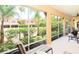 Comfortable, covered lanai with plush seating and views of the lush landscaping and nearby houses at 3655 Square West Ln # 9, Sarasota, FL 34238