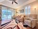Cozy living room featuring hardwood floors, neutral paint, and abundant natural light at 3655 Square West Ln # 9, Sarasota, FL 34238
