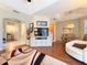 Open-concept living space with hardwood flooring, views of kitchen and access to outdoor living at 3655 Square West Ln # 9, Sarasota, FL 34238