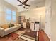 Inviting office space with neutral walls, a ceiling fan, built-in shelving, and a comfortable couch at 3655 Square West Ln # 9, Sarasota, FL 34238