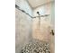 Walk-in shower featuring neutral tile and mosaic flooring at 3655 Square West Ln # 9, Sarasota, FL 34238