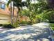 Picturesque street view with manicured lawns and mature trees creating a tranquil setting at 3655 Square West Ln # 9, Sarasota, FL 34238