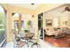 Inviting sunroom with outdoor dining set, seamlessly connecting to a cozy living room with bright, natural light at 3655 Square West Ln # 9, Sarasota, FL 34238
